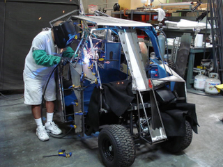 Illustration for article titled Who's foolish enough to not bid on a Batman Tumbler golf cart?